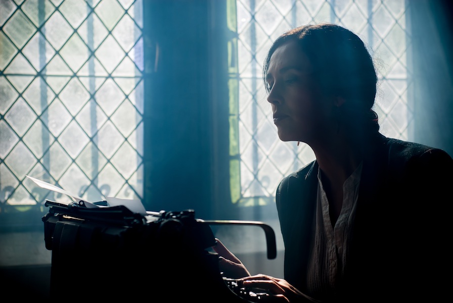 Woman writing on a typewriter