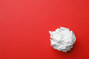 Crumpled sheet of paper on color background, top view. Space for text